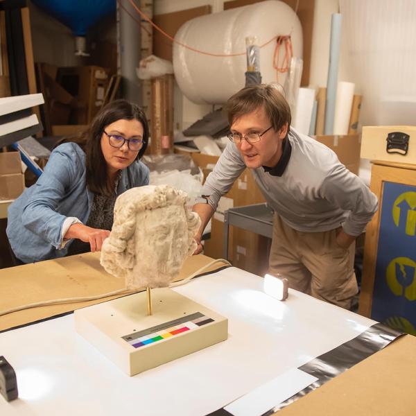 Jennifer Feltman and Alexandre Tokovinine documenting sculptures from Notre Dame